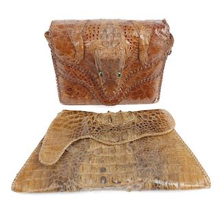 Two crocodile skin handbags. The fist small box satchel, featuring a full crocodile head  on the dou