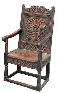 Charles II Oak Wainscot Armchair, having carved panel back, circles over wood seat, carved skirt, turned supports, circa 1660, height 43 1/4 inches, s