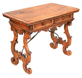 Spanish Style Table, having two drawers, carved legs and iron stretchers, height 27 inches, top 20 1/2" x 31 1/2".