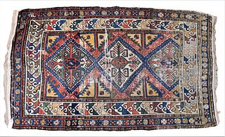Caucasian Oriental Throw Rug, 5' 8" x 3', worn and cut, probably 19th century. Provenance: Estate of Florence Yannios, Waterfront Home, Guilford, CT.