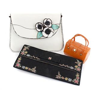 A selection of bags. To include a hand painted clutch by Waldybag, three small metal mesh disc bags,