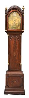 Benjamin Maud English Mahogany Tall Clock, having leaf carved top with three finials and tombstone glass door, flanked by brass top, fluted columns, i