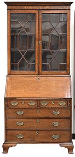 Oak Secretary Desk, in two parts, upper section with two glazed doors, on lower section with slant lid over drawers, all set on ogee feet, England, la