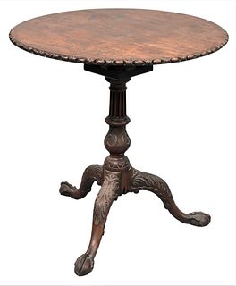 Chippendale Mahogany Tip and Turn Tea Table, having carved edge on fluted and carved pedestal on tripod carved legs, ending in pad feet, height 27 1/2