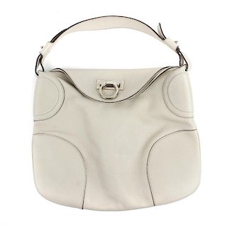 SALVATORE FERRAGAMO - a hobo bag. The cream leather bag, with silver-tone flap clasp fastening, open