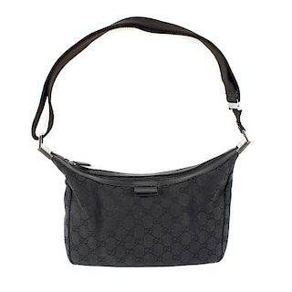 GUCCI -  a GG black canvas shoulder bag. Designed with maker's GG canvas exterior, smooth leather tr
