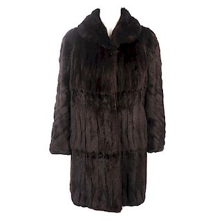 Two knee-length fur coats. To include a dyed ermine coat, designed with a lapel collar and hook and