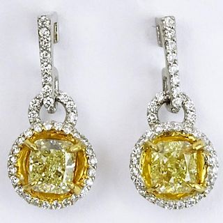 Pair of Approx. 1.40 Carat Radiant Cut Fancy Light Yellow Diamond, Platinum and Yellow Gold Earrings.