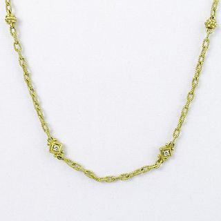 18 Karat Yellow Gold Necklace with Round Cut Diamond Accents.