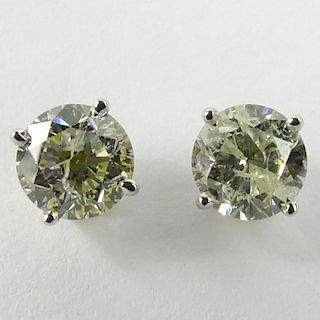 AIG Certified 1.41 Carat Total Weight Round Cut Diamond and 14 Karat White Gold Ear Studs.