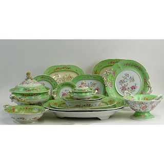 63 piece antique hand painted porcelain partial dinnerware set. Includes: 24 plates, 12 salad plates, 12 soup plates; 6 platters, largest measures 21"
