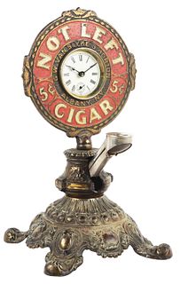 EARLY CAST IRON CIGAR CUTTER WITH CLOCK.