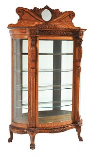 LARGE CLAWFOOT SERPENT CURVED-FRONT CURIO CABINET.