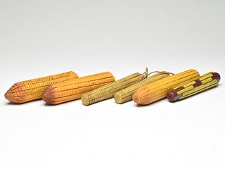 Six ears of wooden corn.