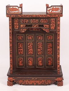 A Chinese Lacquer and Carved Shrine Cabinet