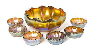 A Tiffany Studios Gold Favrile Glass Bowl and Six Salt Cellars, Diameter of bowl 6 1/4 inches.