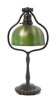A Tiffany Studios Favrile Glass and Bronze Lamp, Height overall 18 1/8 x diameter of shade 7 1/8 inches.