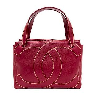 A Chanel Dark Red Caviar Leather Handbag, 11" x 8" x 3.75".