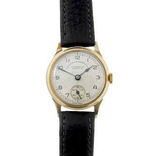 GOLDSMITH & SILVERSMITH CO. LTD - a gentleman's wrist watch. 9ct yellow gold case with engraved case