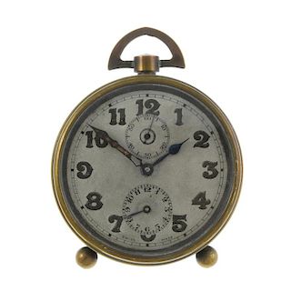 An alarm clock by Zenith Watch Co. Brass case, numbered 16638. Manual wind movement with alarm compl
