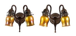 A Pair of Tiffany Studios Gold Favrile Glass and Bronze Two-Light Sconces, Height 10 1/2 x width 9 1/2 inches.
