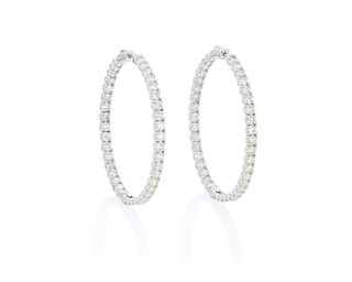 A pair of large diamond hoop earrings