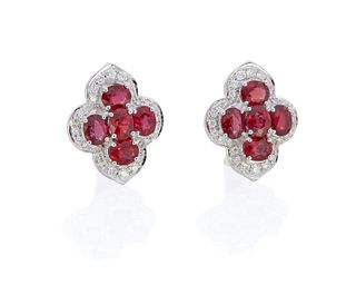 A pair of ruby and diamond clover earrings