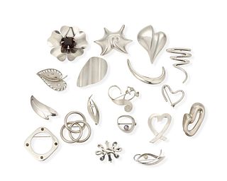 A large group of silver brooches