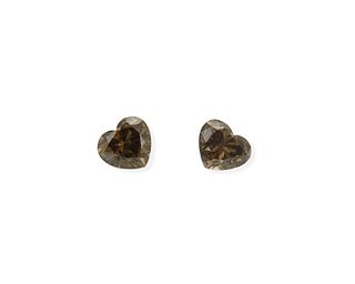 A pair of unmounted heart-shaped diamonds