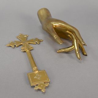 Two heavy brass pieces including coptic procession cross and a molded woman's hand. cross: ht. 9 1/2 in.; hand lg. 8 1/2 in.