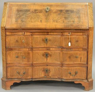 Walnut, burl, and elm desk having slant lid over three drawers set on bracket feet, Dutch or German 18th century (four brasses missi...