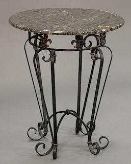 Marble top table with iron base. ht. 31 in.; dia. 26 in.