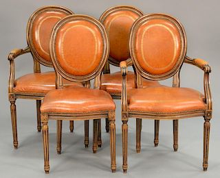 Set of four French style chairs with leather seats and backs including two armchairs and two side chairs.