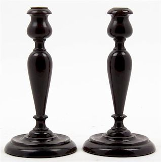 A Pair of Turned Mahogany Candlesticks, Height 9 1/2 inches.