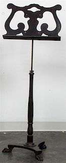 An Ebonized Music Stand, Height 49 inches.