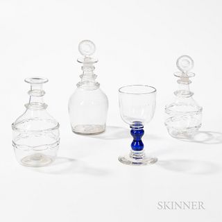 Three Colorless Blown Glass Decanters and a Goblet with a Blue Stem
