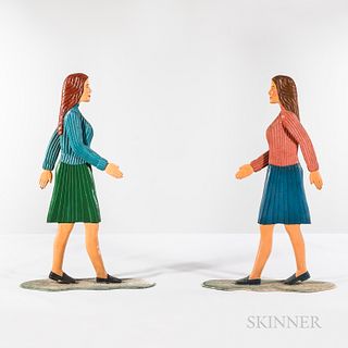 Two Statues of Women in Stride