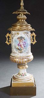 Old Paris Porcelain and Gilt Bronze Oil Lamp, 19th c., the stepped relief bronze bronze top on a floral decorated handled porcelain urn font, on a gil