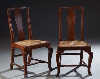 Pair of Irish Carved Oak Rushseat Side Chairs, 18th c., the curved crest rail over a vertical urn shaped splat, to trapezoidal rush slip seats, on poi