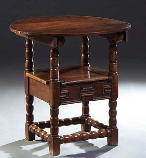 French Carved Cherry Monk's Table, 19th c., the circular table folding back to form the back rest of the chair, over curved arms and a lifting seat ov