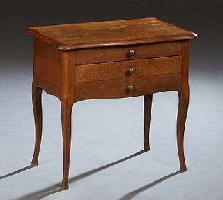 French Louis XV Style Carved Oak Nightstand, 20th c., the ogee edge serpentine top lifting to open storage, over a faux drawer and two shallow drawers