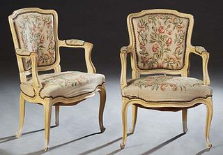 Pair of French Louis XV Style Polychromed Beech Fauteuils, 20th c., the upholstered shield back flanked by upholstered arms, to a wide bowed seat on c