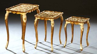 Nest of Three Italian Gilt and Polychromed Nesting Tables, 20th c., with scrolled leaf decoration, the dished rectangular tops on square cabriole legs