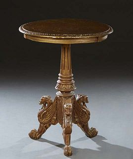 Continental Gilt Carved Beech Gueridon, late 19th c., the circular carved edge top on a tapered reeded urn support, to lion carved tripodal legs with 