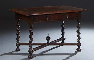 French Provincial Louis XIII Style Carved Walnut Writing Table, late 19th c., the shaped rounded edge top over a wide skirt with one long frieze drawe