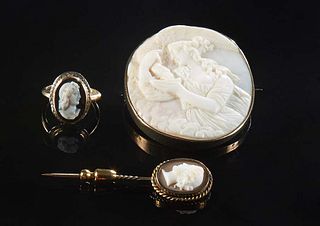 Group of Three Pieces of Cameo Jewelry, consisting of a 14K yellow gold cameo and onyx ring, Size 5; a cameo stick pin; and a large white cameo of a w