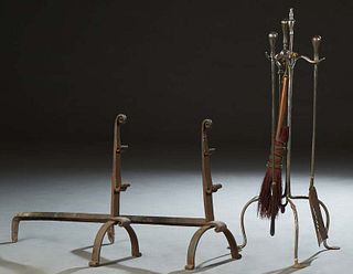 Group of Fireplace Accessories, early 20th c., consisting of a pair of iron andirons mounted with a front poker rack, and a four piece firetool set on
