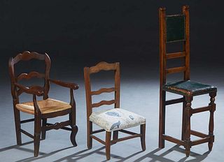 Group of Three Carved Beech Child's Chairs, 20th c., one a highback example with green leather upholstery with iron tack decoration; one a rushseat la