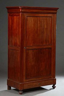 Diminutive French Carved Walnut Bonnetiere, 19th c., the ogee crown over a large two panel door, above a lower drawer, on turned bun feet, H.- 71 1/2 