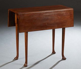 English Carved Mahogany Drop Leaf Table, early 20th c., with rectangular leaves, on cylindrical legs with pad feet, H.- 27 7/8 in., W.- Closed- 14 1/4